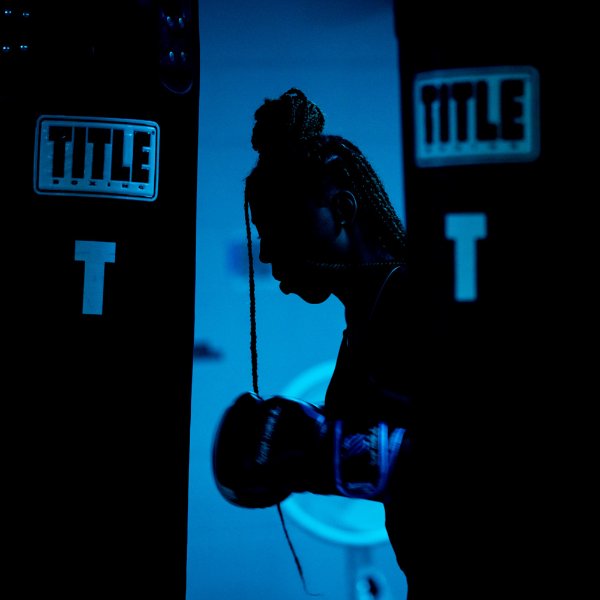 A student is silhouetted while boxing at a university.