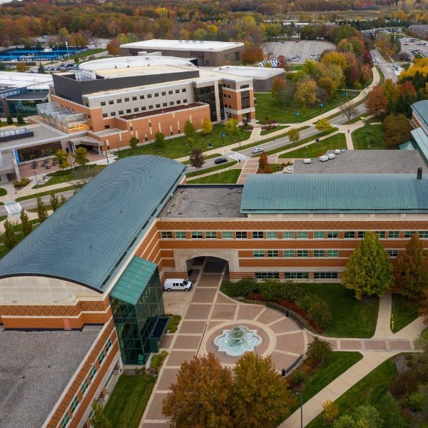 Drone photo of Allendale Campus with focus on student services building, fountain in foreground