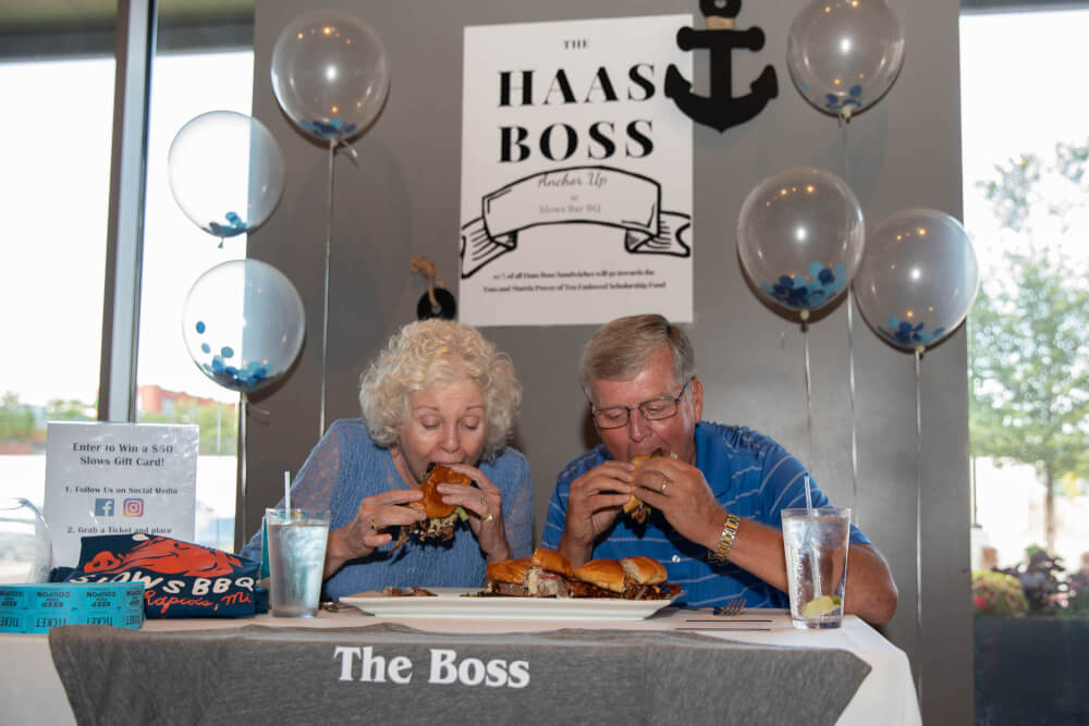 Tom and Marcia Haas taste testing sandwiches seated at table