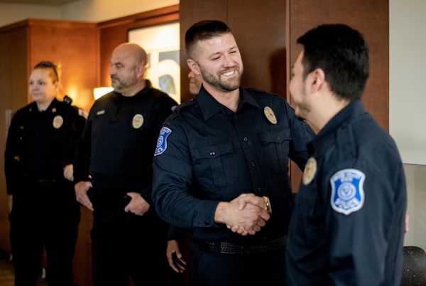 Tom Burns shakes hands with Marco Rojas-Garcia after they were sworn in as officers for the Grand Valley Police Department.
