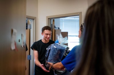 Connor Pung receives a gift basket in his dorm room.