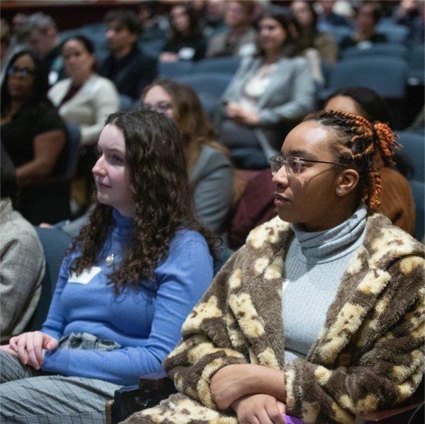 Audience members listen to a speaker in Loosemore Auditorium