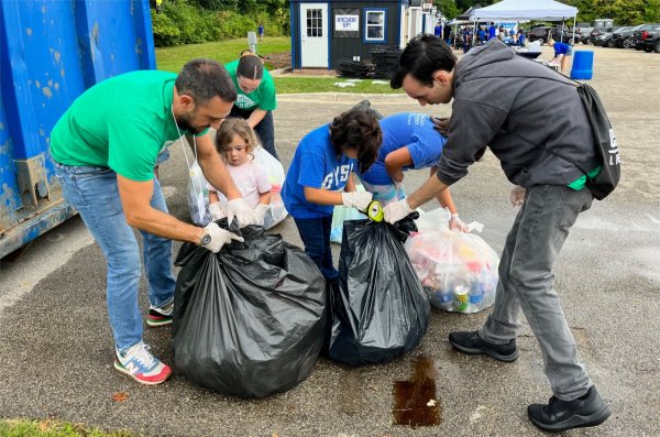 Volunteers from Grand Valley collect trash from a Grand Valley football game as part of the Zero Waste Touchdown Challenge.