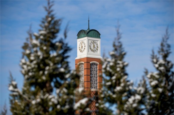 The GVSU Cook Carillon Tower surrounded by snow-covered Trees. 