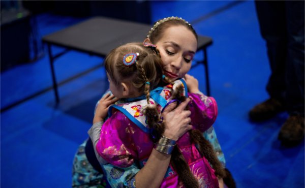 Colleen Graves hugs her daughter, Illiana Graves, 2, before the start of Grand Valley&rsquo;s 23rd annual &ldquo;Celebrating All Walks of Life&rdquo; Pow Wow April 13. Graves said the people at the Pow Wow are like family to her.