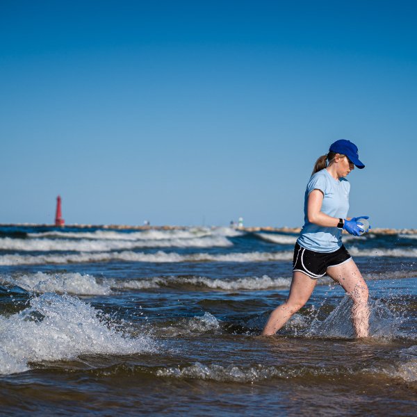 Lexy Porter takes a water sample from Lake Michigan at Pere Marquette Beach in Muskegon.