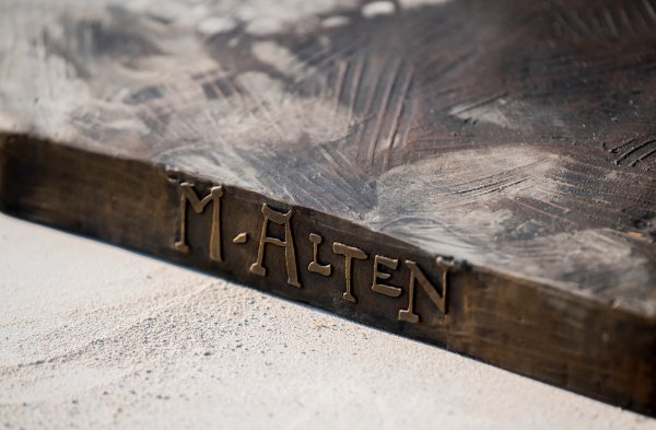 The base of a bronze sculpture has the words M Alten