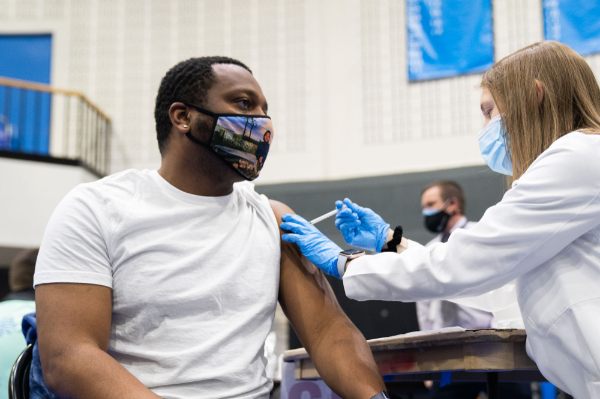 GVSU student Denzel Braswell gets the first dose of the Pfizer vaccine at the Fieldhouse. 