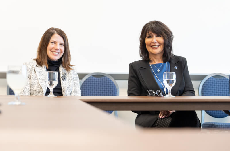 Provost Maria Cimitile, left, and Philomena Mantella, right, sit next to each other at a faculty senate meeting.