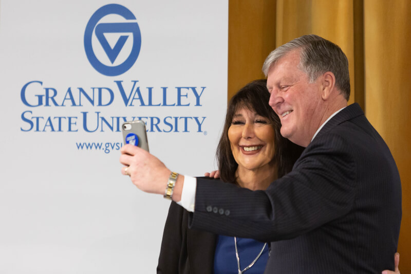 Philomena Mantella poses for a selfie with retiring GVSU President Tom Haas.