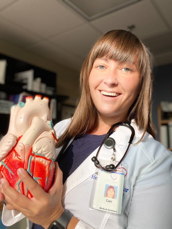 Cari Bellicini holds a plastic heart model at the Michigan Heart and Vascular Specialists, Heart Failure Clinic in Petoskey.