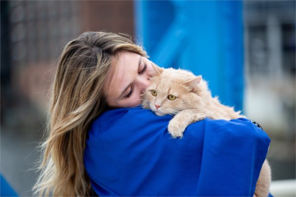  A graduate snuggles with her cat. 