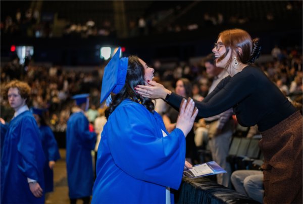 Sisters share a moment during a Commencement ceremony. 