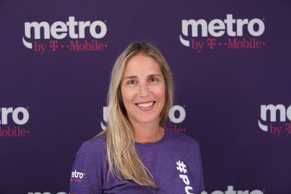portrait of Tara Daggett in a purple shirt in front of a purple background for Metro by TMobile