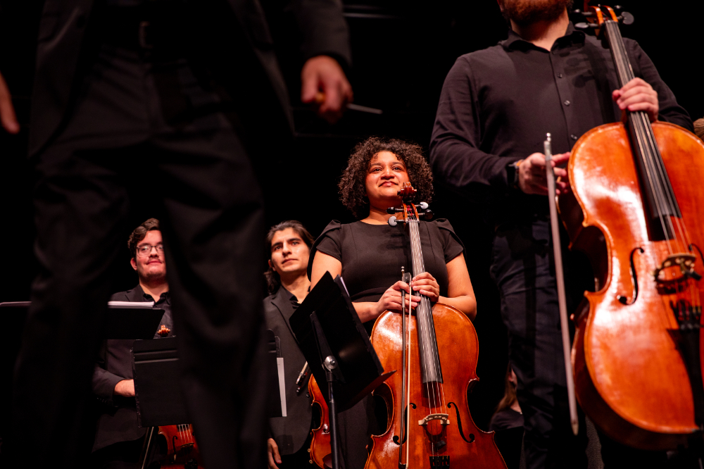 Orchestra students in concert black, looking forward
