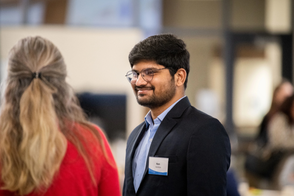 Ram Kandula, right, talks with others during the Demystifying the Visa Hiring Process event at DCIH February 21.