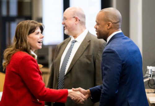Andrea Leslie, senior vice president of hospital operations at Corewell Health, left, shakes hands with fellow panelist Brandon Francis, chief medical officer at Trinity Health St. Mary&yacute;s, during the Health Economic Forecast 2025. The event was held at th