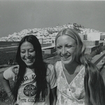 black and white photograph of two GVSC students in front of cityscape and ocean