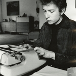 Bob Dylan seated at desk