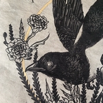 Detail of blackbird with flowers around it