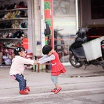 two young girls playing in the street
