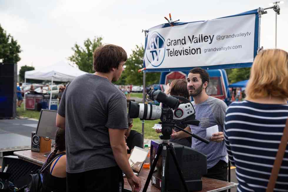 A student at the GVTV booth shows camera equipment