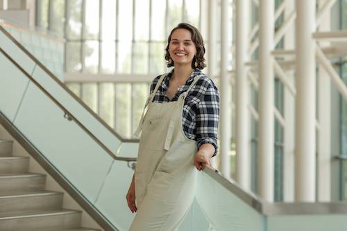 Leah Erben standing on the Mary Idema Pew Library steps 