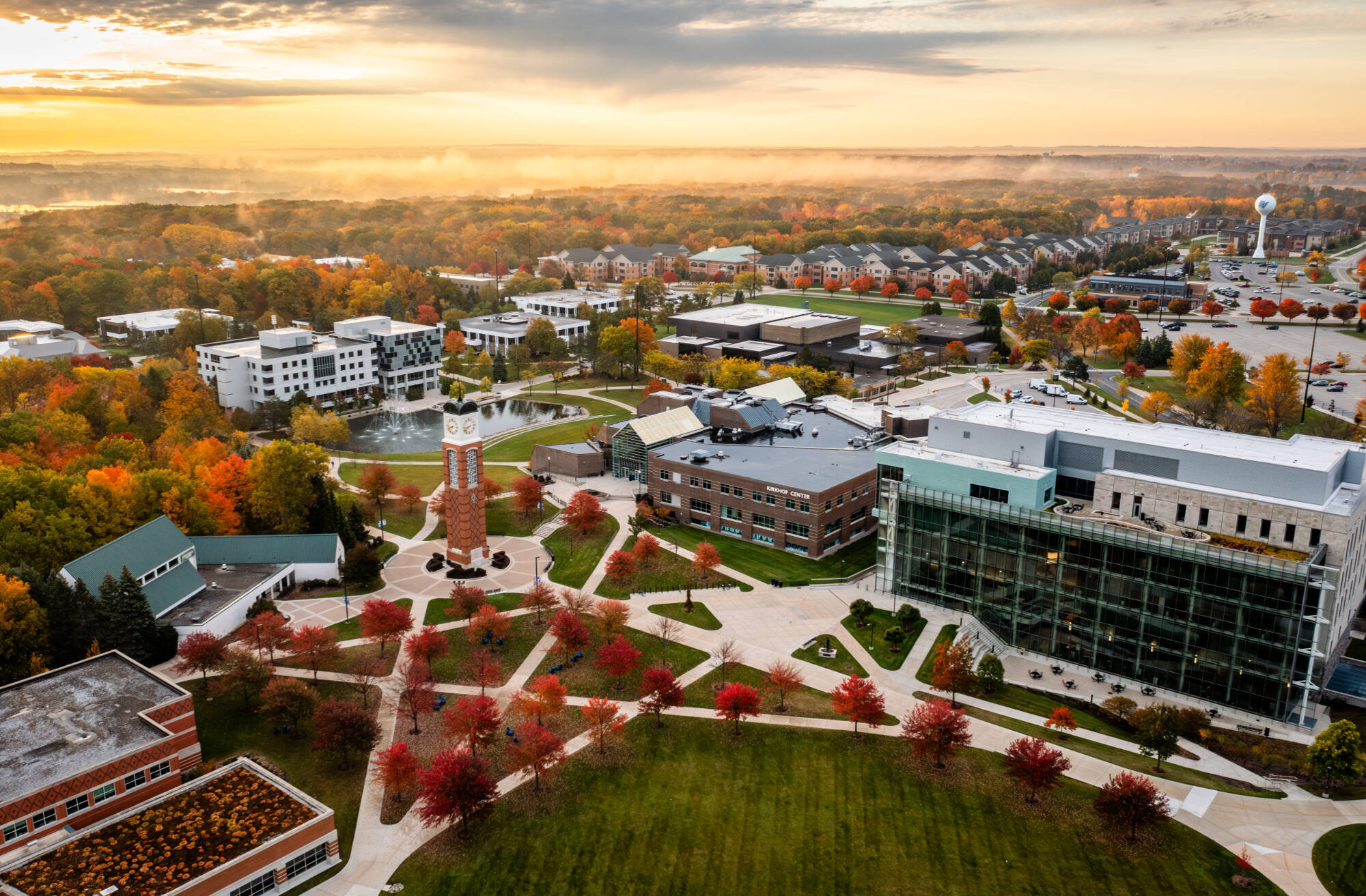 drone shot of campus, in october with red leaves on trees, the clock tower, kirkhof, and the library