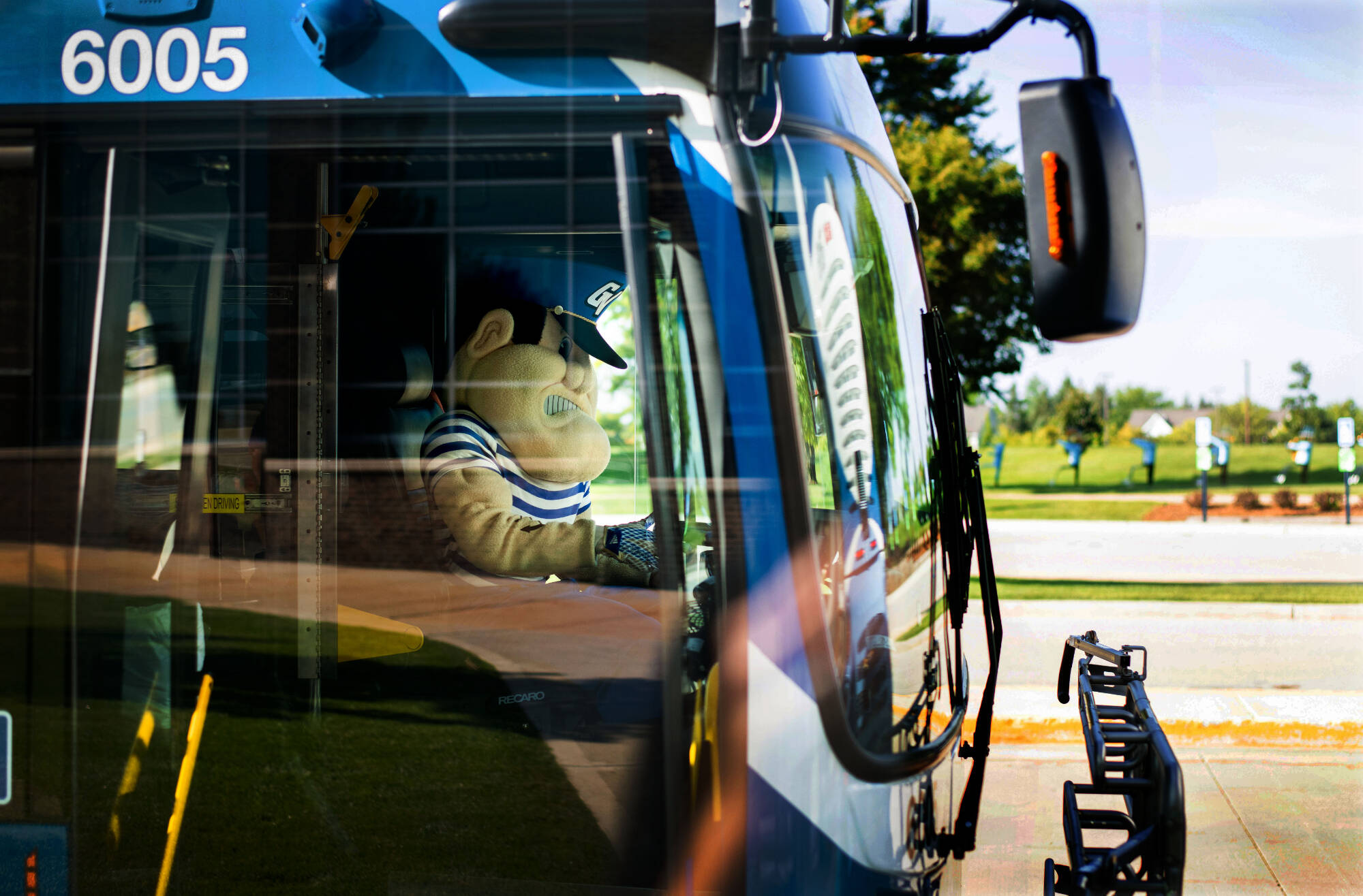 Louie the Laker driving a city bus