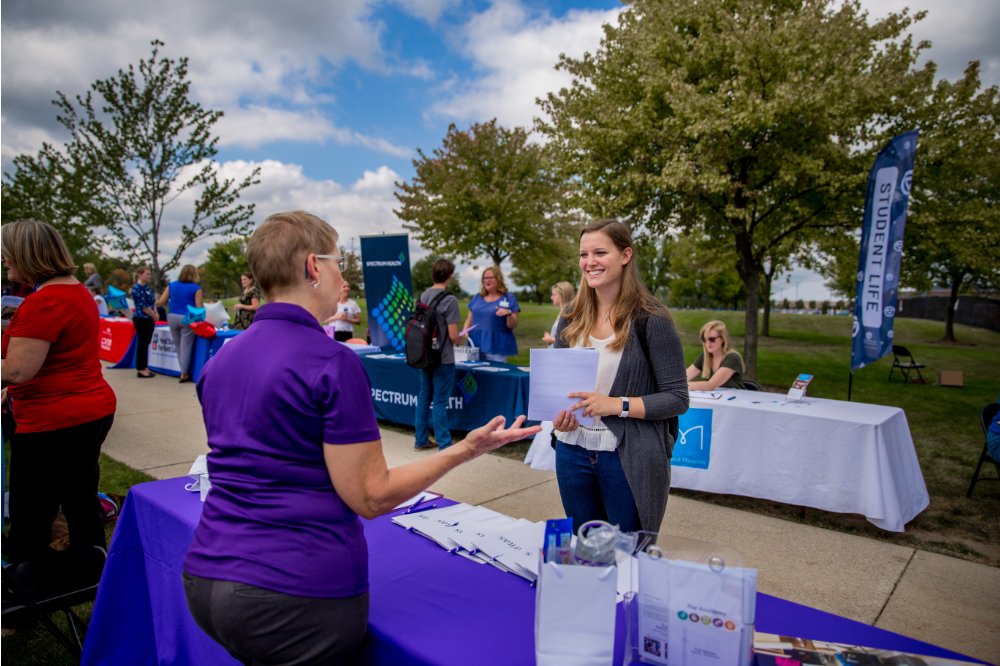 A student talking to a non-profit staff member