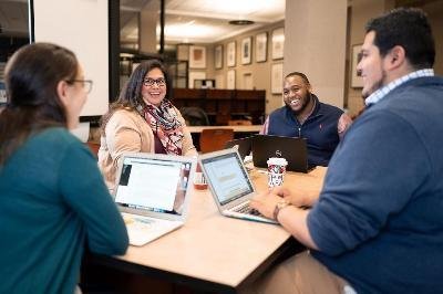 4 people engaging in conversation