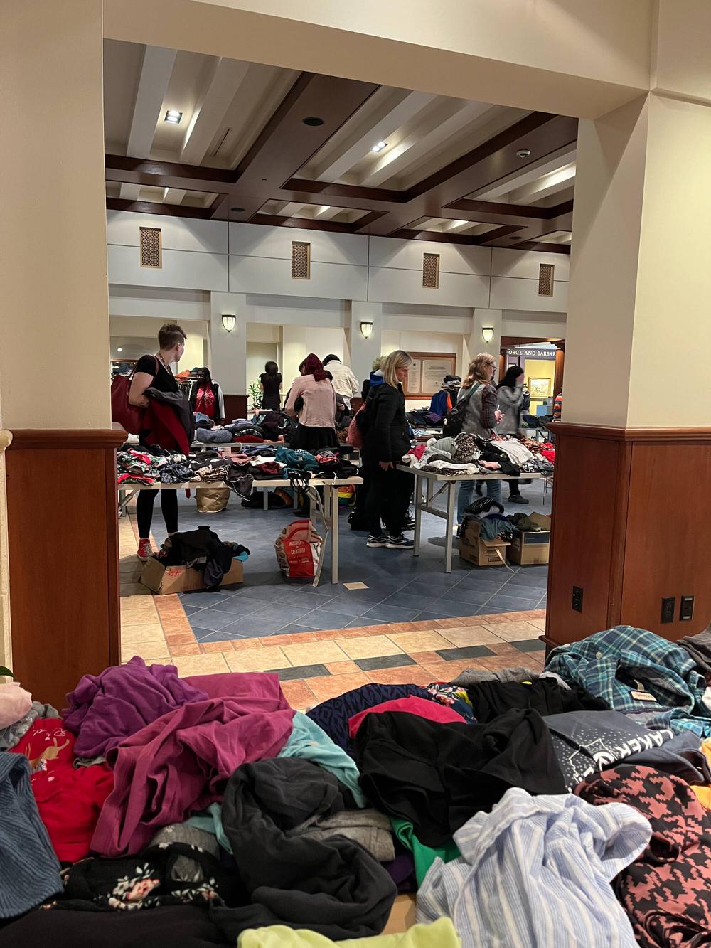 Tables are filled with colorful clothing as guests check out the options at Wear the Rainbow in 2024.
