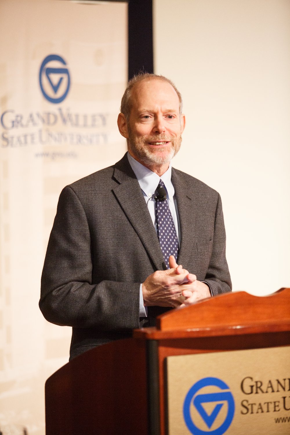 Man speaks to audience in Loosemore