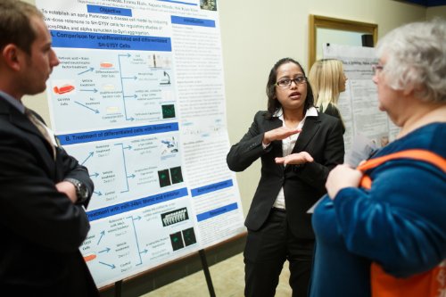 Student Discusses Research  with Attendee