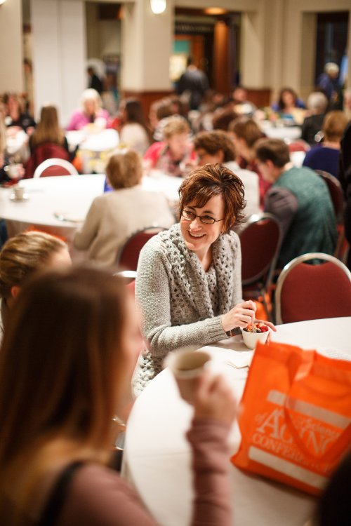 Attendees are networking at tables