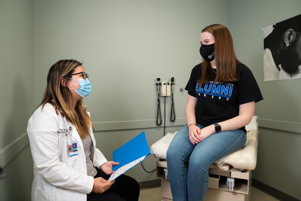 Graduate student talking with patient