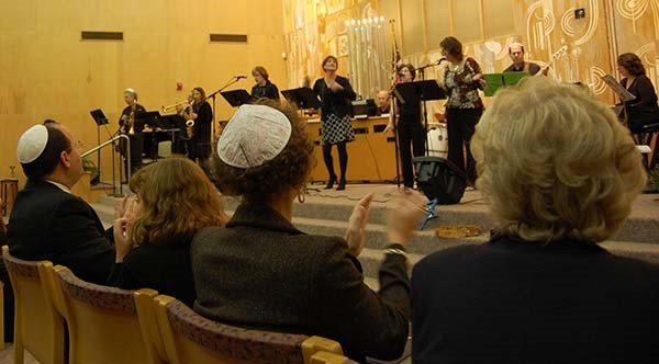 people clapping and singing in worship