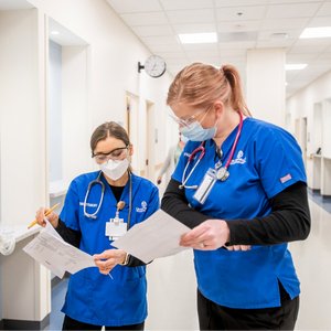 Student nurses comparing paperwork