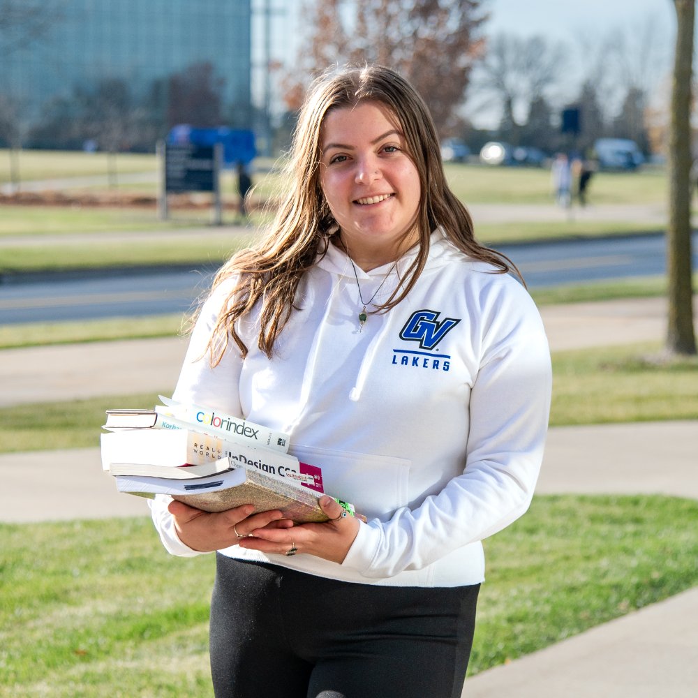 Student holding textbooks.