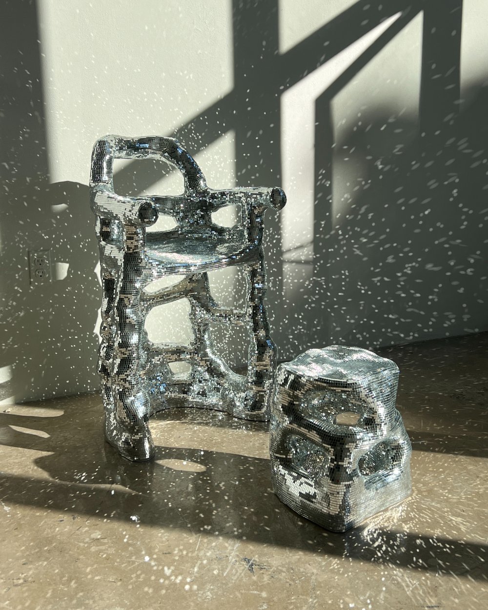 Two metallic art pieces in the sunlight