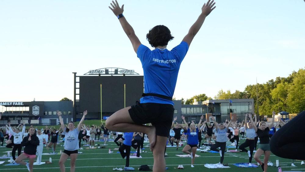 Yoga practice on Lubber's Stadium field