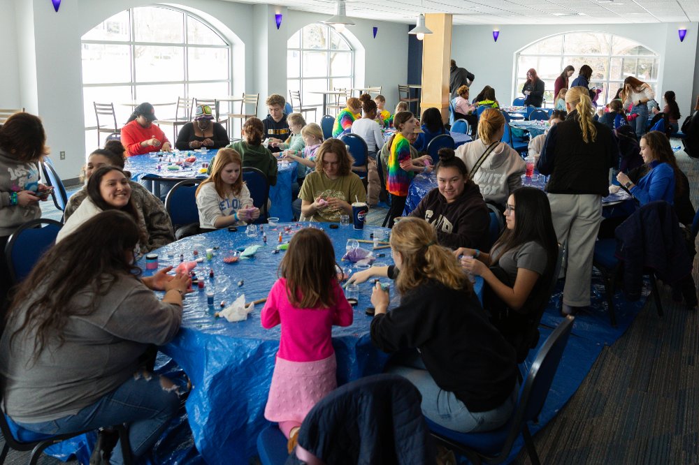 lots of students and children sitting at round tables