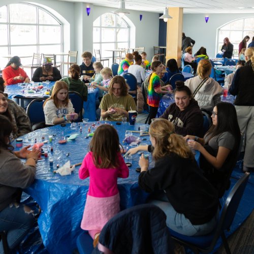 lots of students and children sitting at round tables
