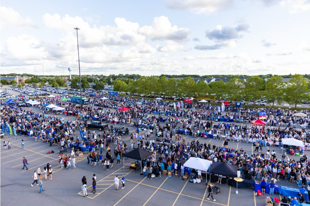 Bird's eye view of a parking lot filled with students