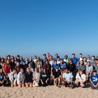 All students take a picture after a successful beach clean up
