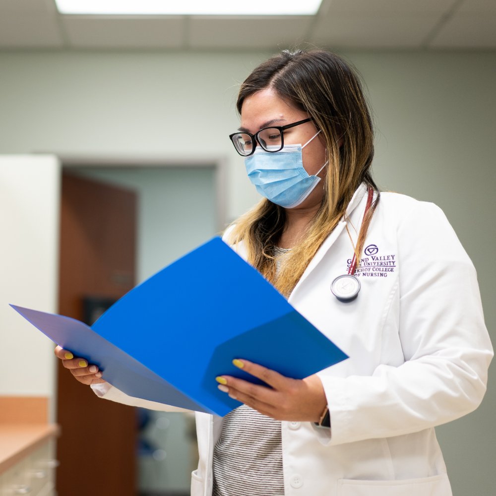 Graduate student in a client reviewing a chart.