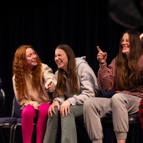 students sitting in chairs participating in show