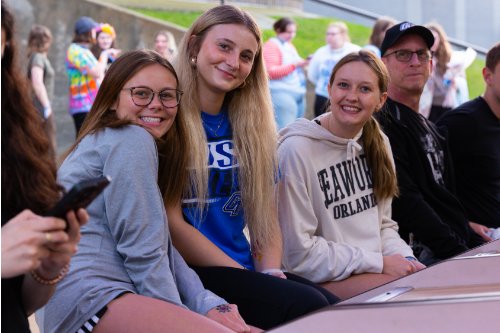 students sitting in front of carnival game