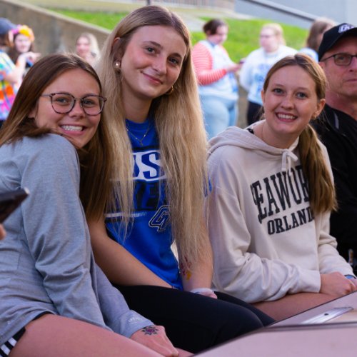 students sitting in front of carnival game