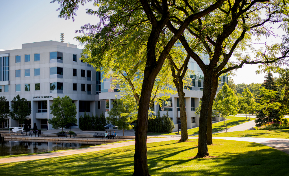 Zumberge Hall pictured with pond on left side